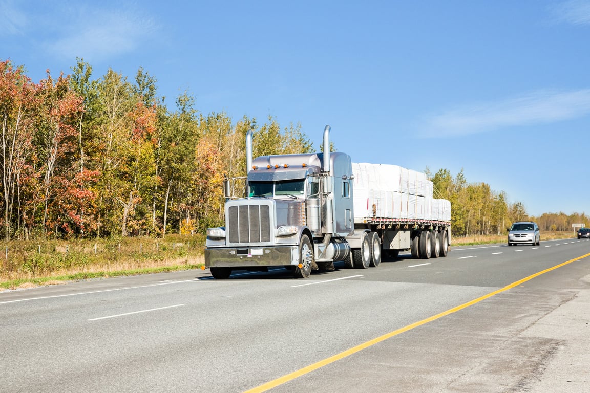 Flatbed trailer truck on a multi lane highway  RM